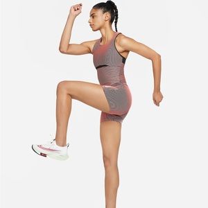 Nike Dri Fit NWT Romper/Unitard Size Medium. Pale Coral/Black/Black/White